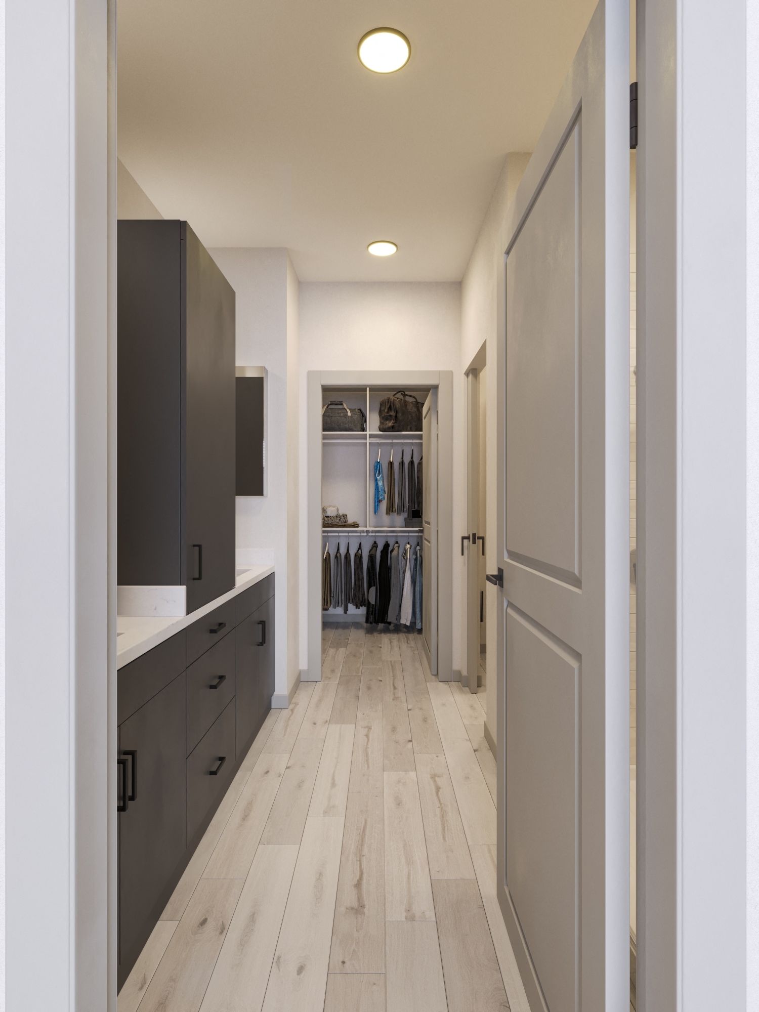 View looking into master bathroom from the bedroom with black cabinets, granite counter tops, vinyl flooring and access to walk-in closet